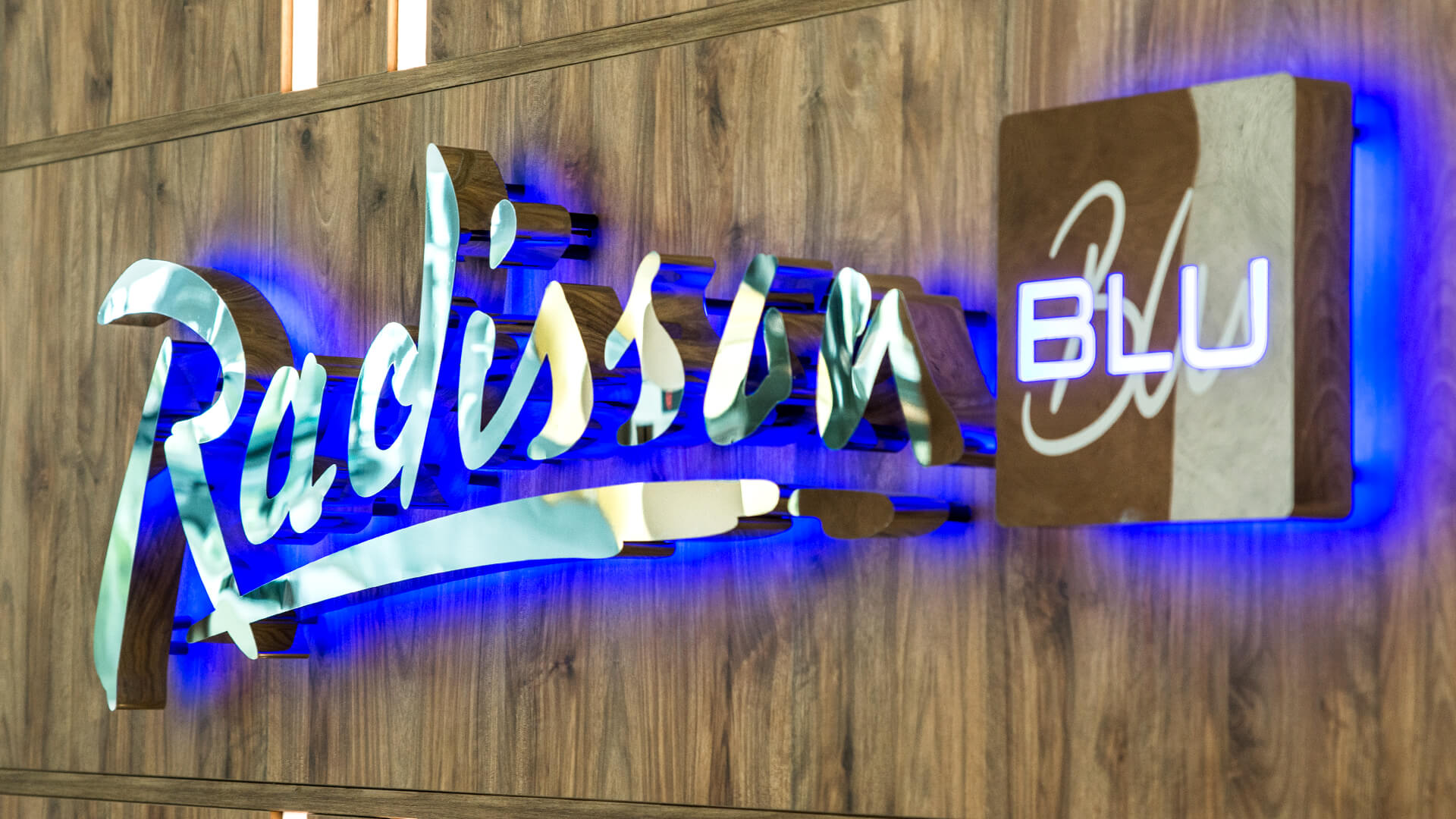 radisson sopot blu hotel - radisson-blu-letters-from-steel-sheet-metal-gold-letters-behind-reception-in-hotel-on-a-wooden-wall-letters-lit-from-back-to-blue-sopot-logo-company-exclusive-glamour
